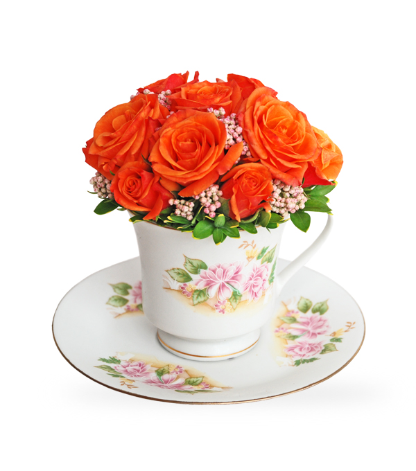 Tea Party a flower tussy-mussy in a tea cup from orage spray roses by Sun Flower Gallery.